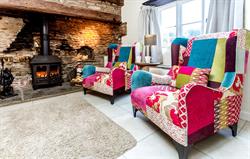 Comfortable chairs next to log fire