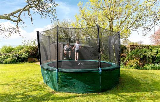 Orchard garden with trampoline and swings