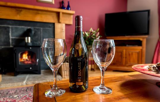 Enjoy a glass on wine in front of the fire
