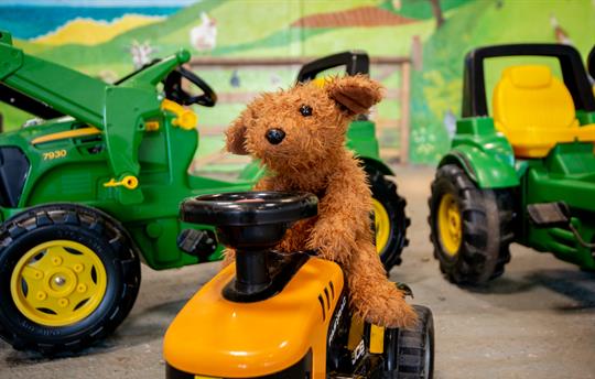 Anyone can take a turn driving in the play barn