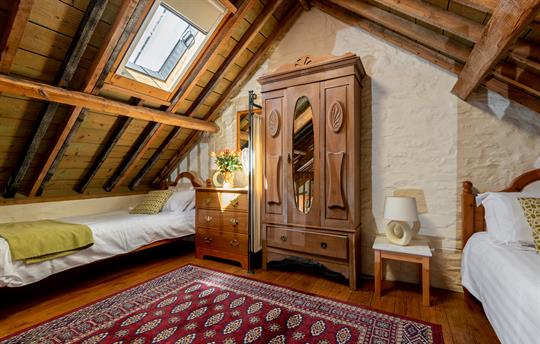 Open plan twin bedroom under the rafters