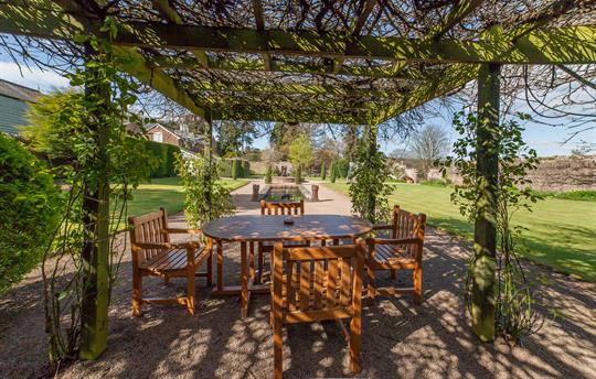 Take a seat, relax in the spacious walled garden
