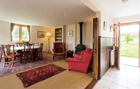 Stables dining room opening into garden
