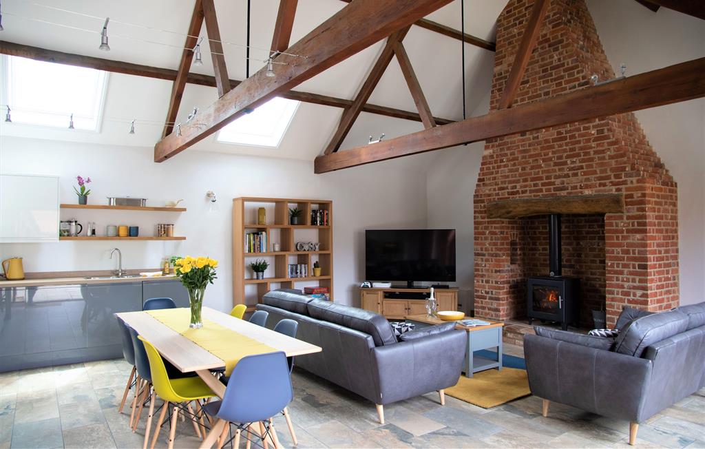 Large open plan living space with woodburner