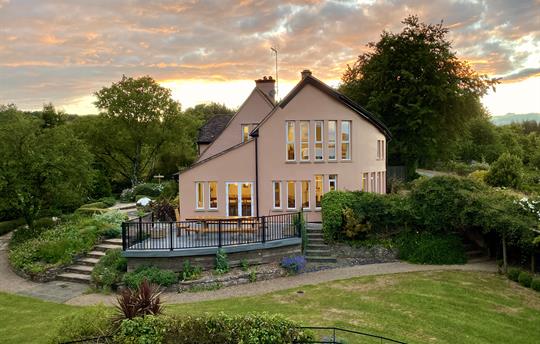 Sunset over the house and large garden.