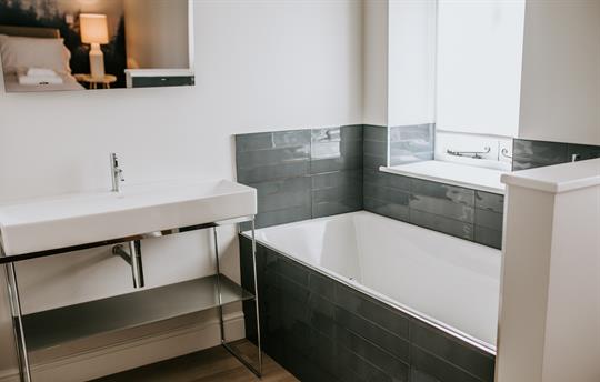 Middle bathroom with mirror tv 