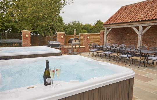 Outdoor area with hot tubs, bbq and pizza oven
