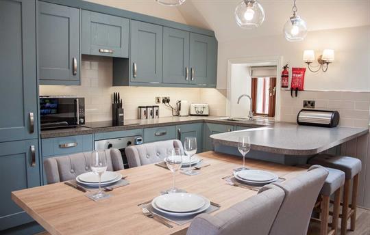 Dining table and kitchen of Farndale Cottage