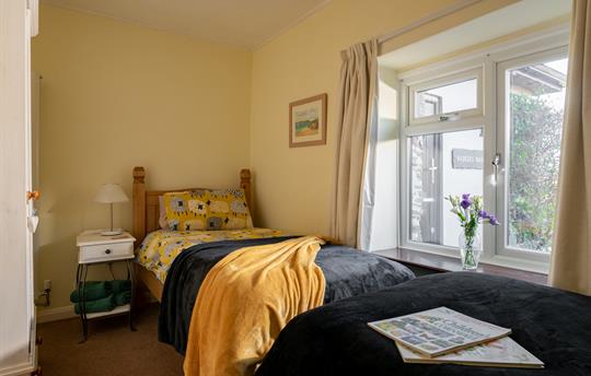 Twin bedroom with wardrobe and chest of drawers