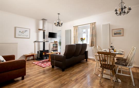 Spacious open plan living room with log burner