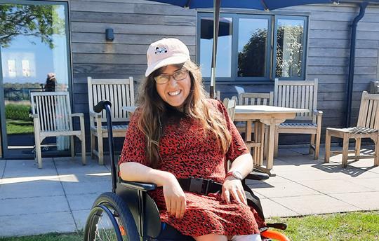 Accessible guest enjoying the sun in Teal Garden