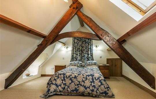 Master bedroom with original wooden beams