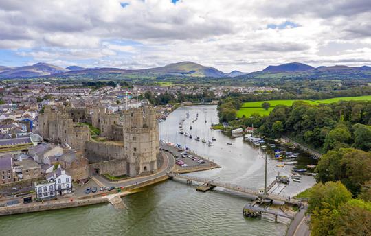 Caernarfon Castle and the mountains of Snowdonia 