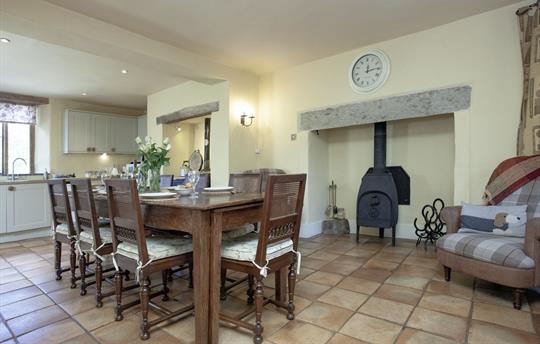 Farmhouse open plan kitchen dining w/ woodburner