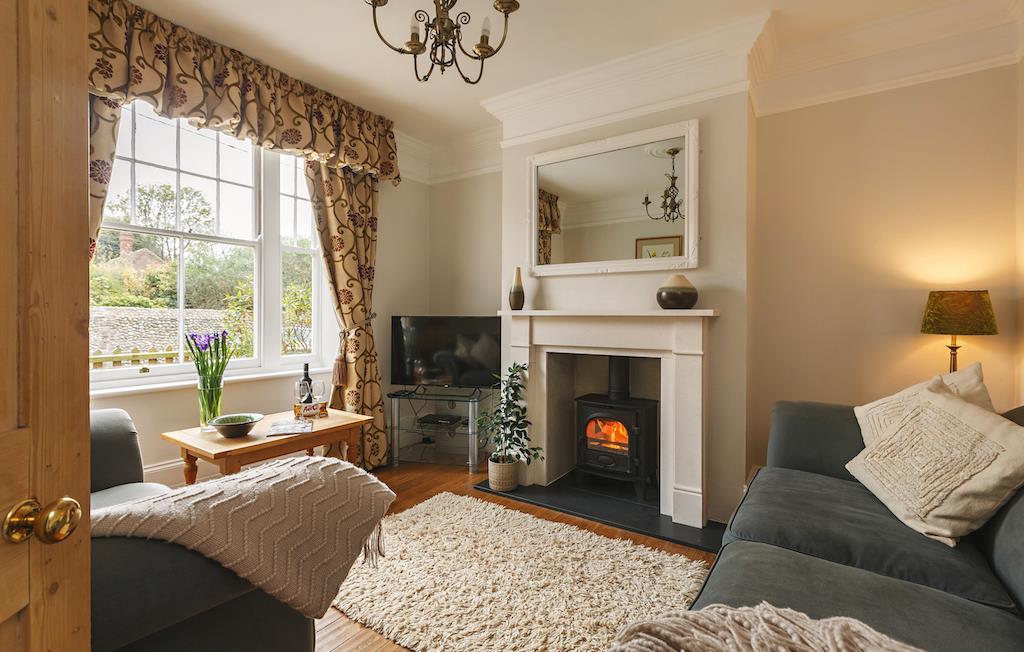 Bright cosy lounge with woodburning stove
