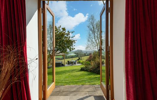 Linhay bedroom patio doors to garden and hot tub.