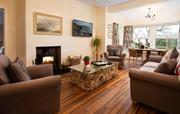 Sitting room with wood burner and bay window