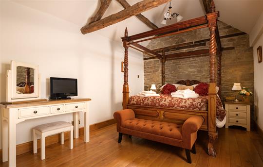 Master bedroom with grand four-poster and ensuite