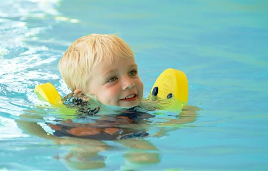 Children swimming in indoor pool