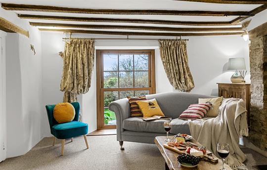 Sitting room with exposed beams & cosy sofas