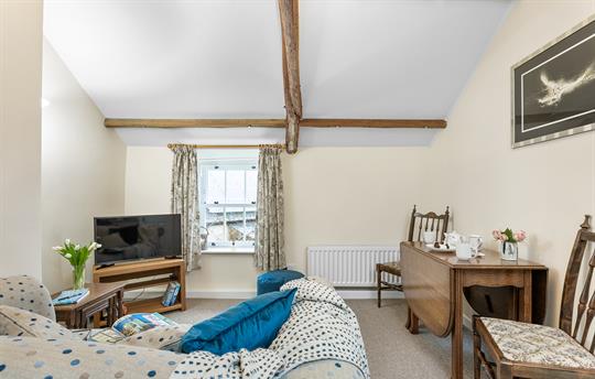 Open-plan lounge with comfy sofa and Smart TV