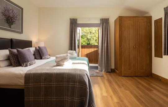 Bedoom 4 with patio doors to the shared balcony