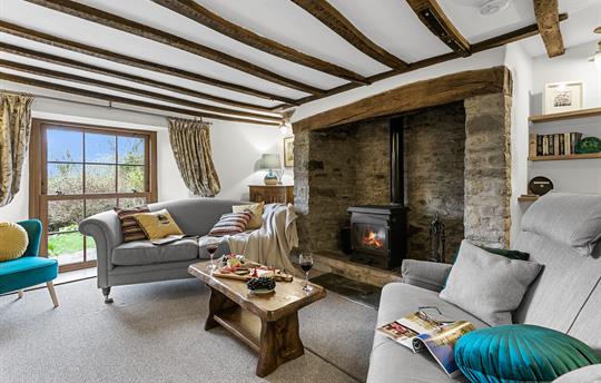 Cosy sitting room with woodburner & exposed beams