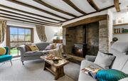 Cosy sitting room with woodburner & exposed beams