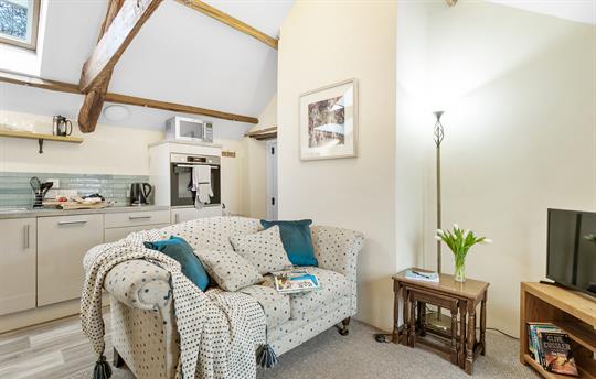 Open-plan 2nd lounge with comfy sofa and Smart TV