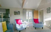 Bright and cosy sitting room with doors to garden