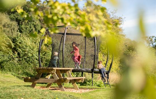 Trampoline in play area with children