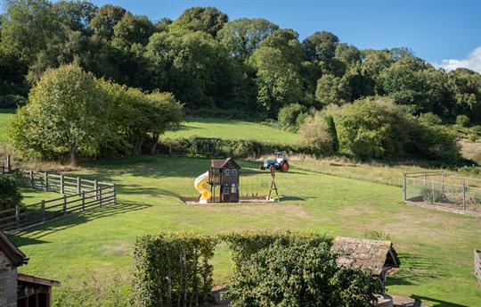 Play area - trampoline, tractor, swings and slide