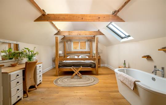 Master bedroom upstairs with 4 poster bed and bath