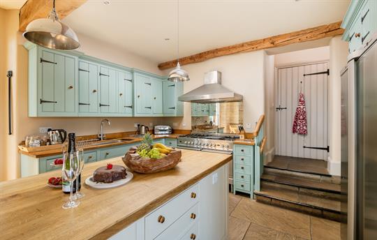 Open plan kitchen with steps up to the hallway