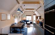 Open plan cooking and dining in Stone Barn