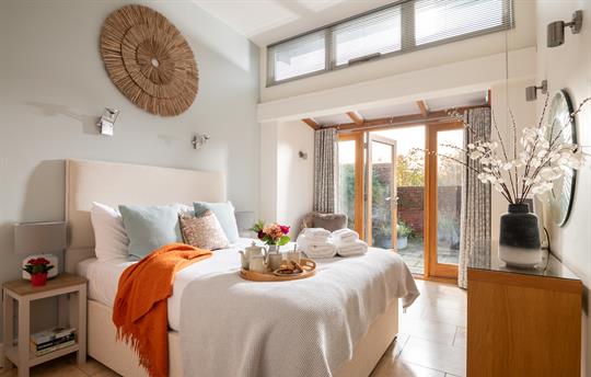 Garden House master bedroom leading to patio