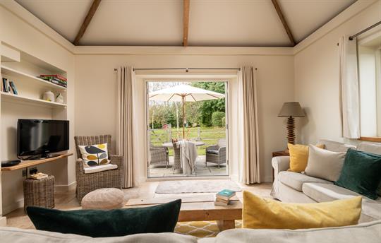 Avocet living space overlooking patio and gardens