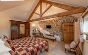 Bedroom features original exposed wall & oak beam
