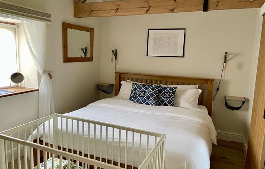 The Master Bedroom with our small cot