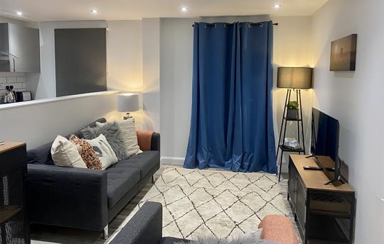 Sitting area with comfortable sofa and smart tv.