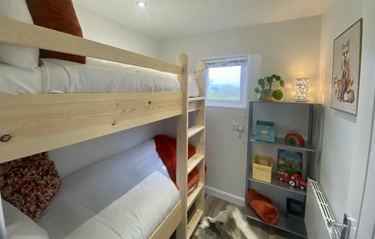 Bunk room with bespoke handcrafted bunk beds.
