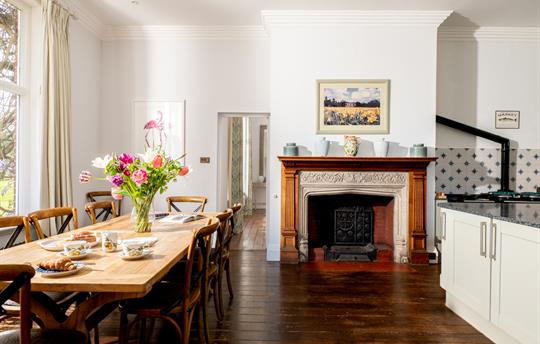 Large kitchen with table and fireplace