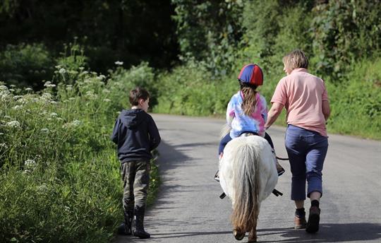 cottage guests riding the pony