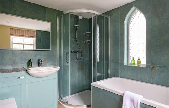 Bathroom in the turret with feature gothic window 