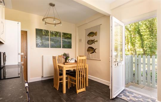  Light airy kitchen has door to patio