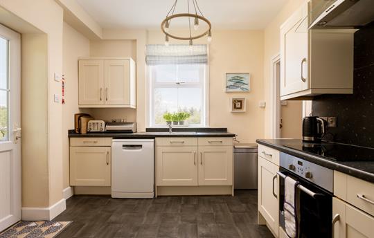 Kitchen with dishwasher and tall fridge/freezer