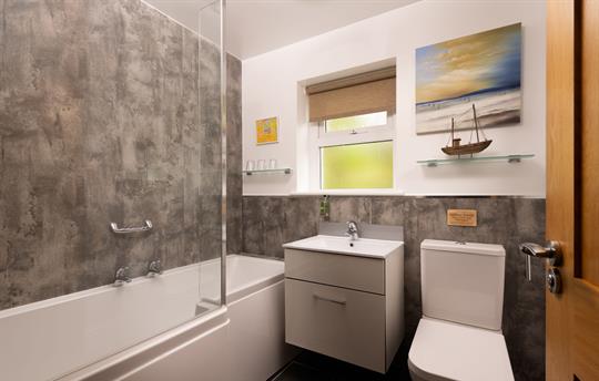 Ground floor bathroom with shower over bath