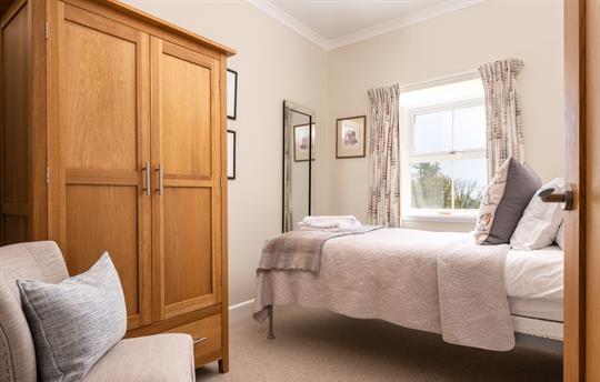 Single bedroom next to bathroom