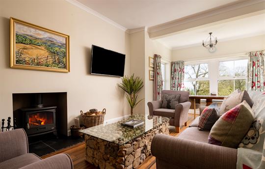 Sitting room with wood burner and large bay window