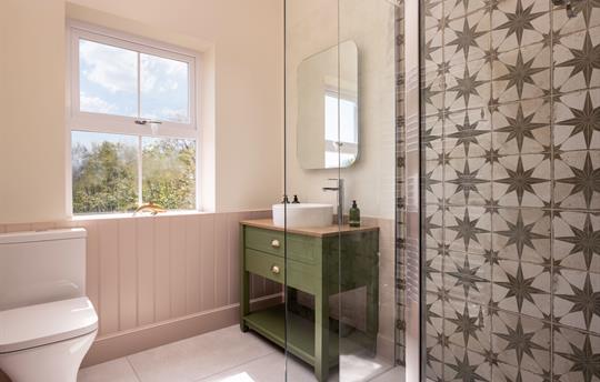 Shower room adjacent to twin bedroom